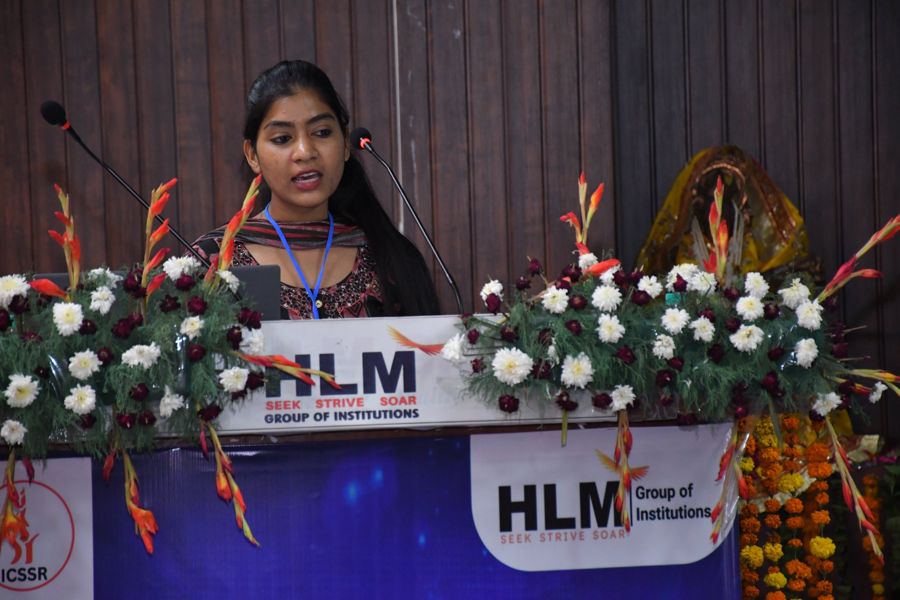 Delegate presenting a research paper at the HLM podium